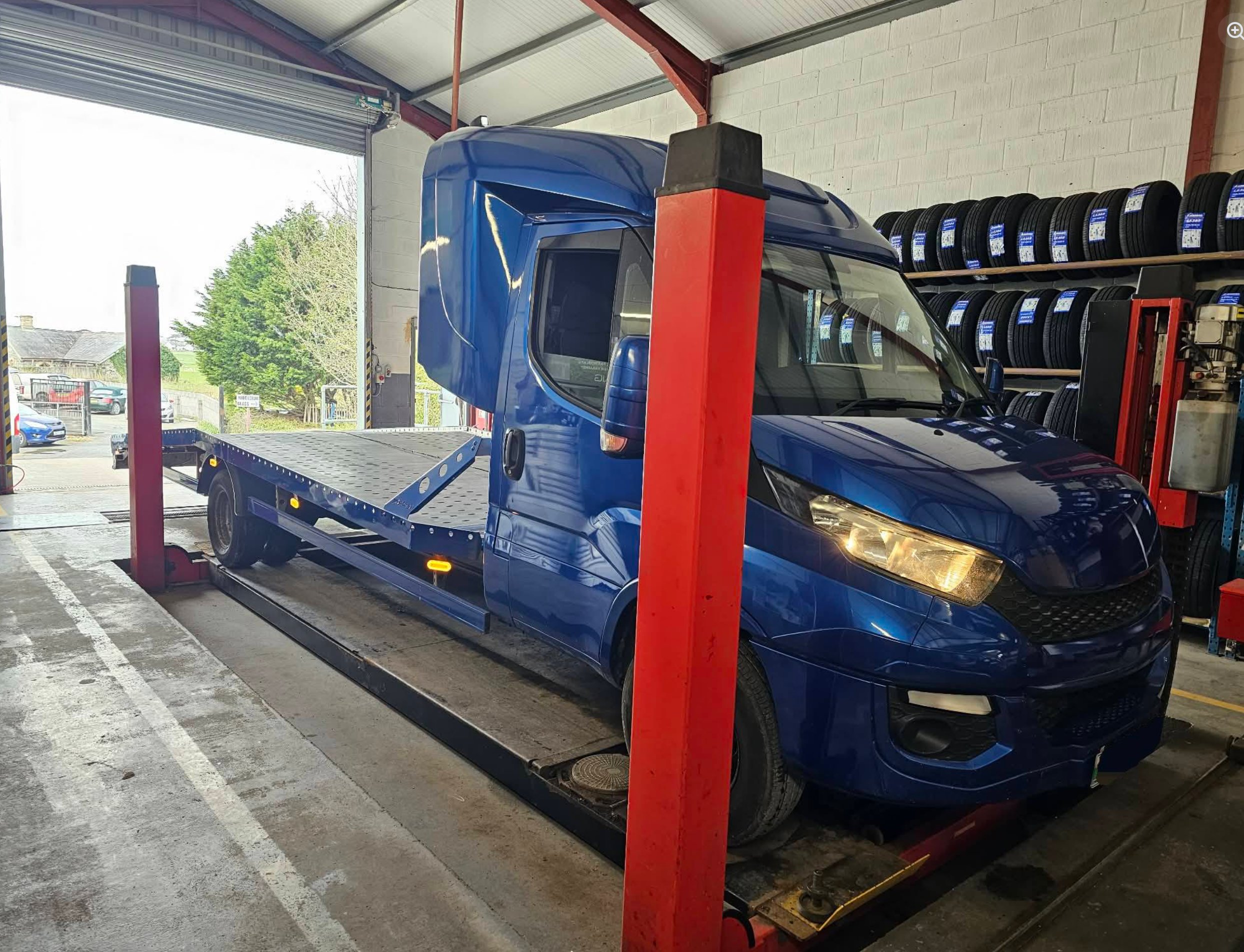 Class 7 MOT test at Modurol Dyfi Tywyn — commercial vehicle on hydraulic lift in the workshop